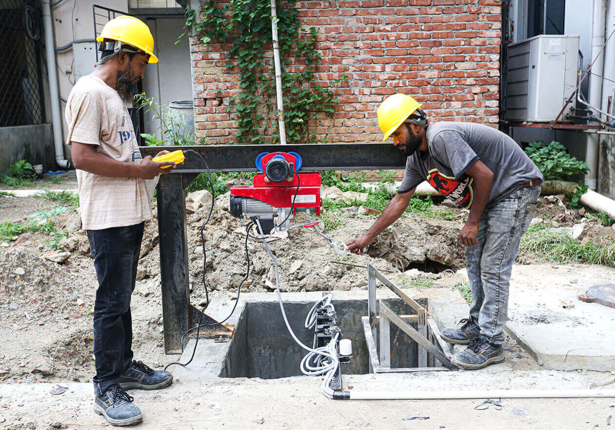 two men are working on a machine